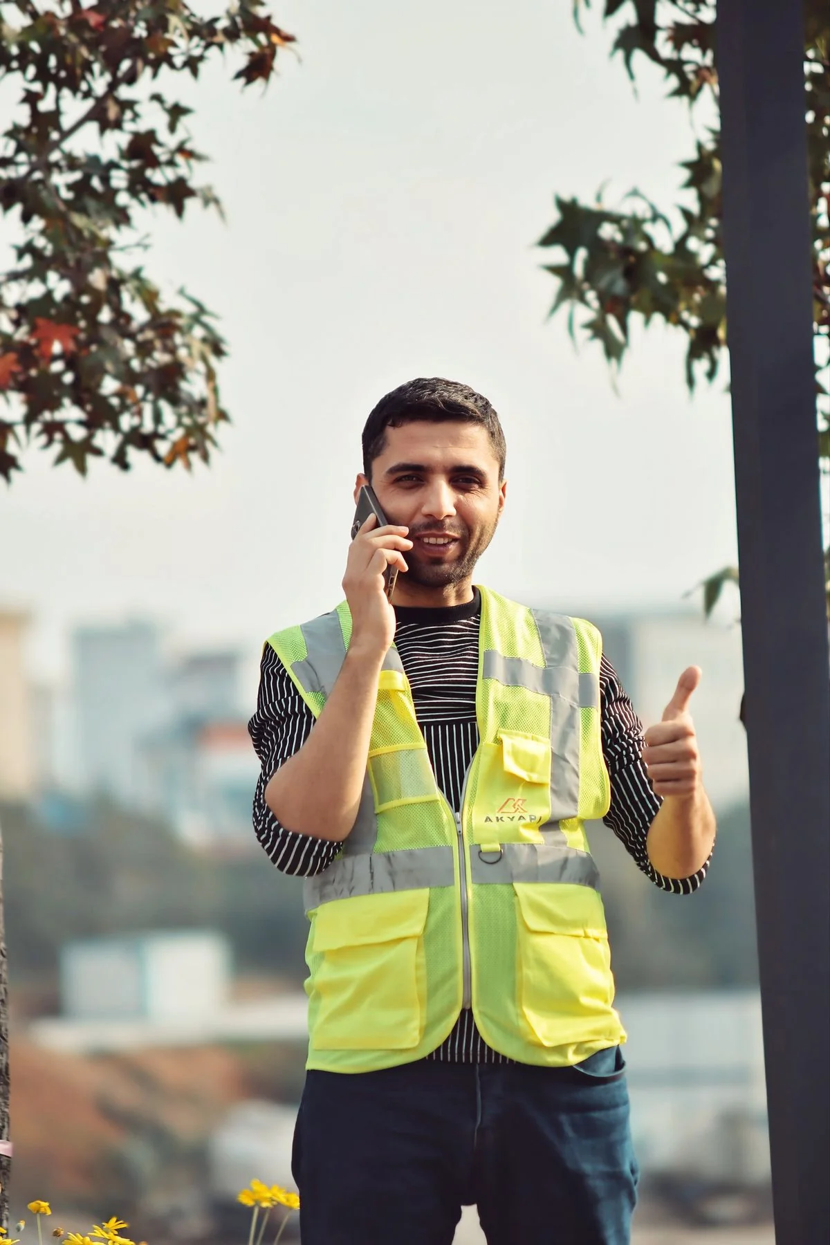 Construction worker in a safety vest talking on a phone