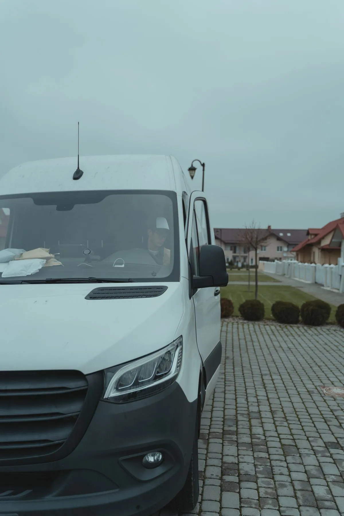 Contractor reviewing bid paperwork in a work truck before a site visit