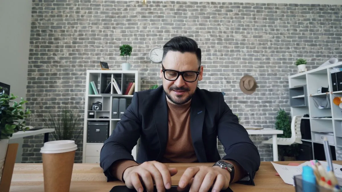 Small business owner working on a laptop at a desk with coffee