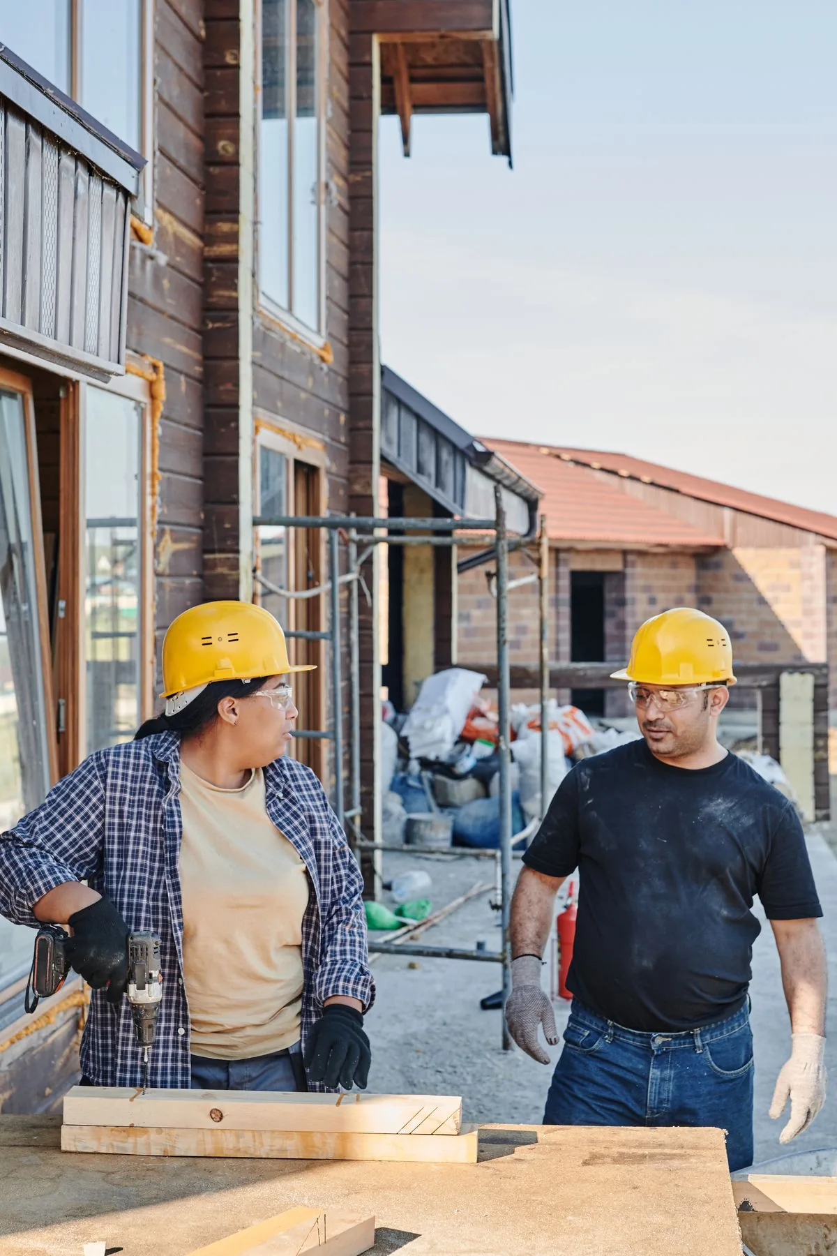Two construction workers discussing plans together