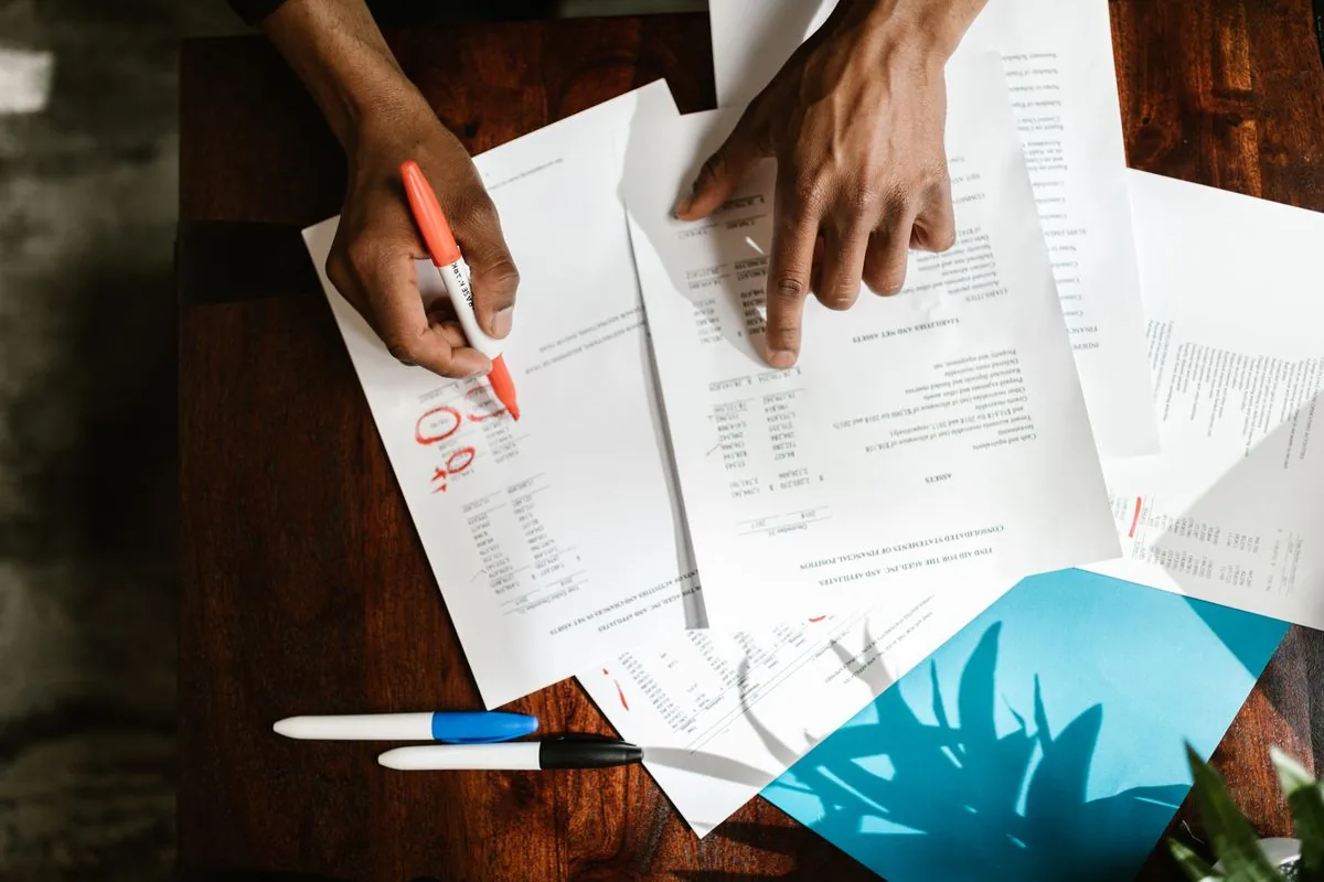 Hands sorting through invoices and payment paperwork