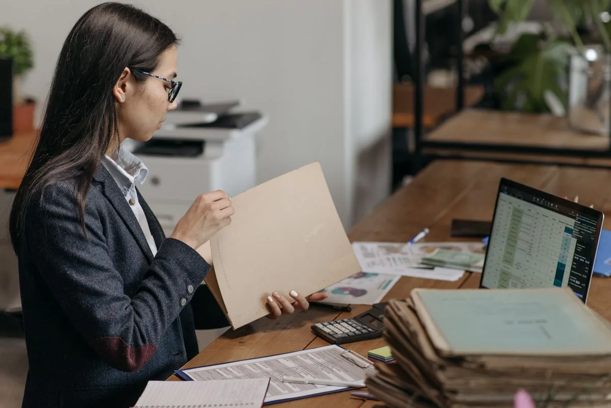 Contractor reviewing paperwork and costs at a home office desk