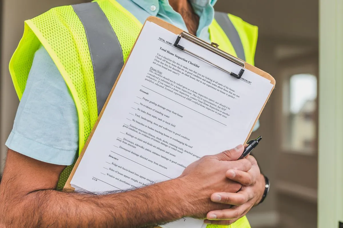 Contractor and homeowner doing a final walkthrough with a punch list clipboard