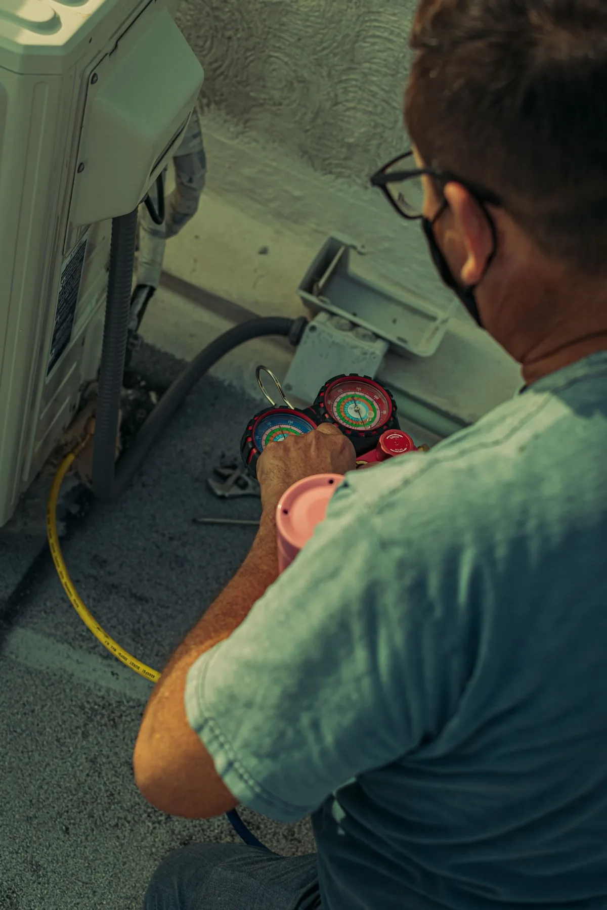 HVAC technician servicing an outdoor air conditioning unit