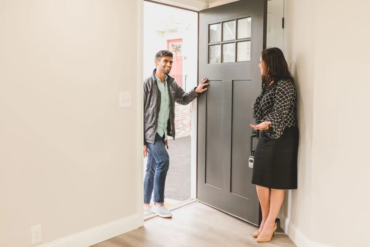 Plumber presenting a service agreement to a homeowner at the door