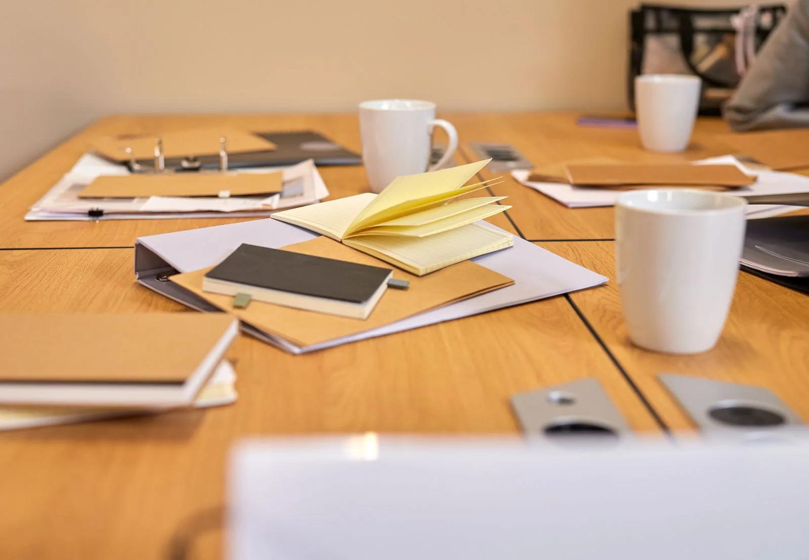 Open notebooks and file folders spread across a meeting table