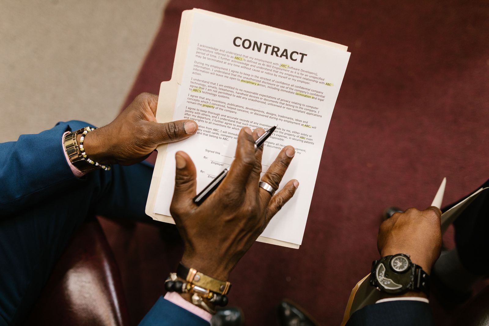 Overhead view of hands signing a business contract